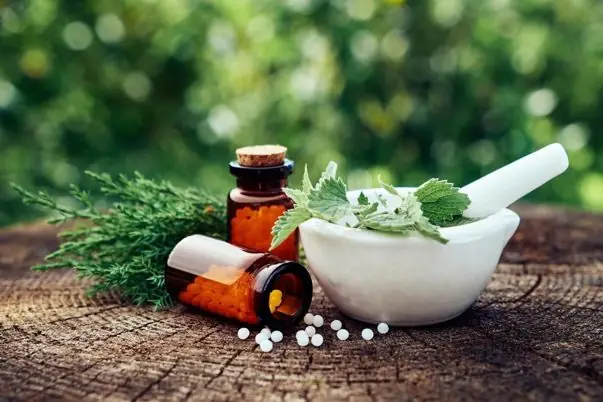 Herbs and mortar with pharmaceutical bottles